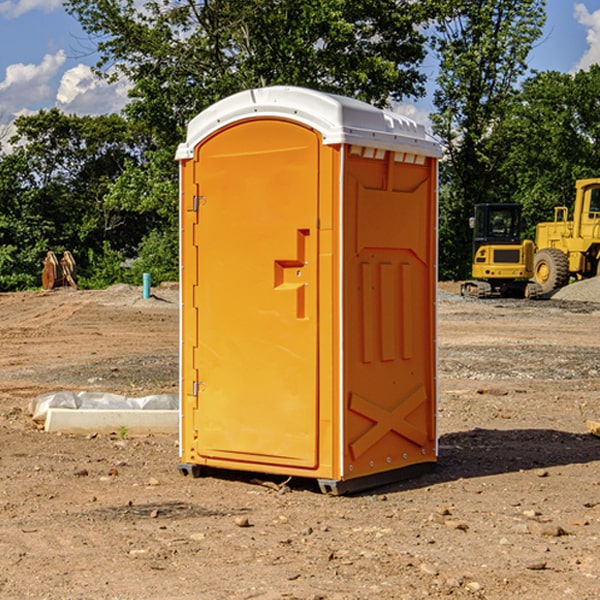 what is the cost difference between standard and deluxe portable toilet rentals in Brick Center